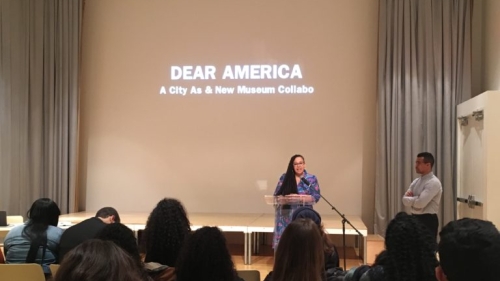 Tiffany in front of screen giving a lecture