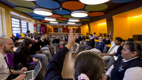 students raising their hands