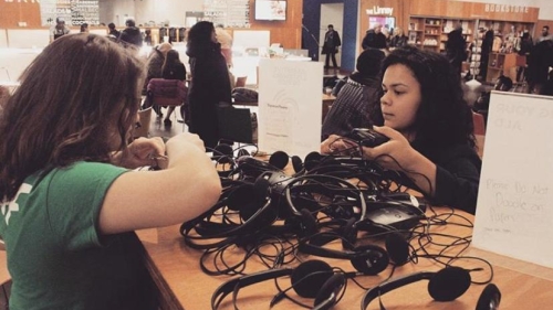 Destiny Lopez and unidentified woman examine amplification technology.