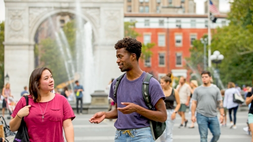 Two students take a walk through Washington Square Park