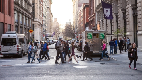 A crowded crosswalk on Washington Place and Broadway