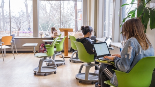 Students lounge and study in the first floor lounge at Pless Hall