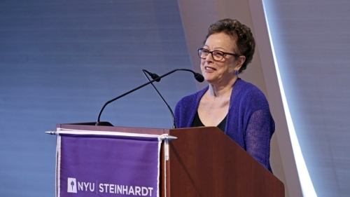 Ann Marcus speaks at a lecturn