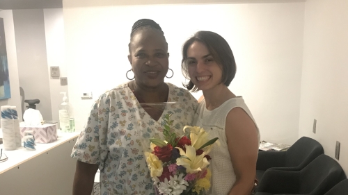 Katarzyna Borkowska holding a bouquet of flowers standing next to a person in scrubs.