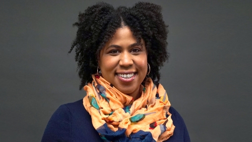 A headshot of Dr. Stephanie Cook wearing an orange scarf