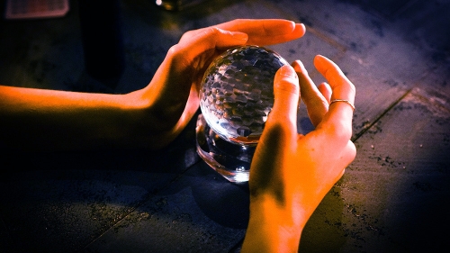 Hands around a crystal ball