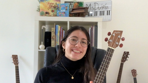 student holding guitar