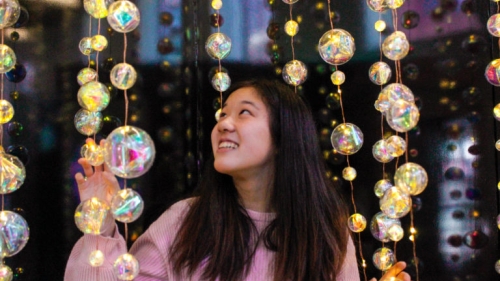 woman within crystal globe chandelier 