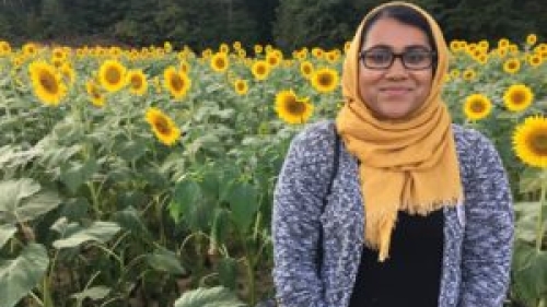 woman on front of a field of sunflowers