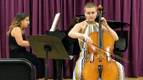 woman at piano and woman at cello on stage
