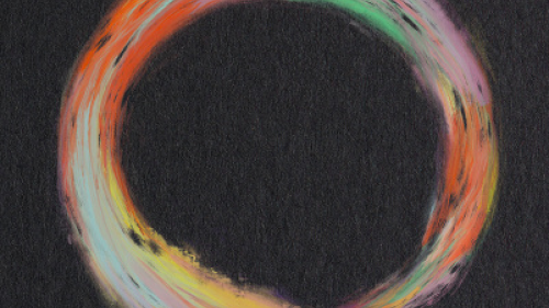 A multicolored circle on a black background from the cover of Creative Infrastructures