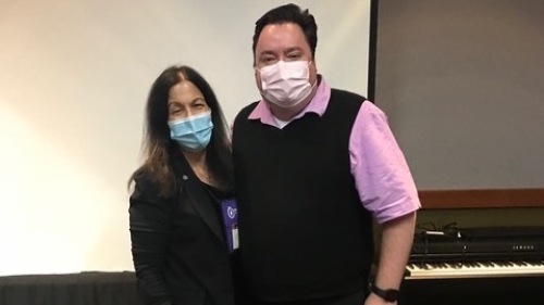 woman and man pose in front of keyboard