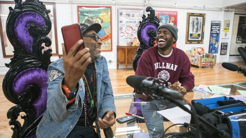 Filmmaker Spike Lee shows Xavier Jernigan an image on his phone.