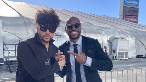 Portrait of Bad Bunny and Xavier Jernigan outside near a stadium entrance