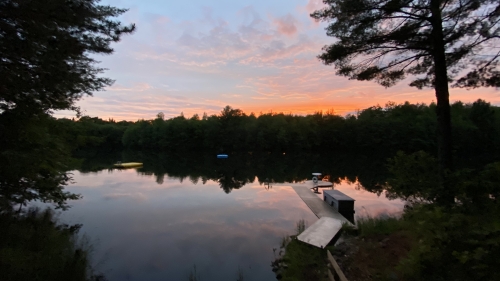 Sunset over a lake view from the family cabin of Hunter Hanson