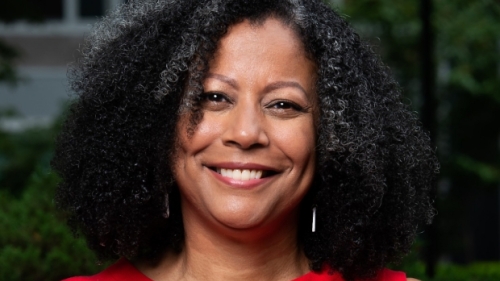 Portrait of Fabienne Doucet in a red shirt with a v-neck color