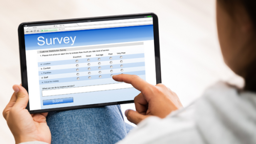 Girl filling out survey on tablet