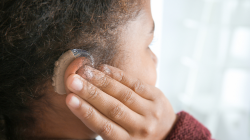 Closeup of black girl with hearing aid