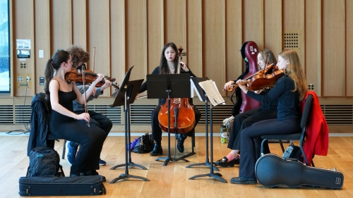 NYU violinists playing in Paulson Center