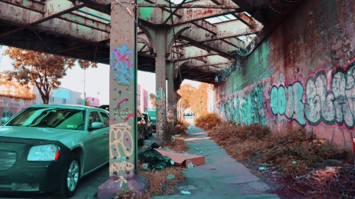 Graffiti letters under a bridge.