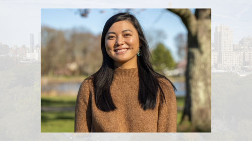 Image of one person outside standing near a tree
