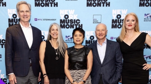NYU faculty in front of NY music month step and repeat