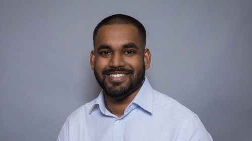 Image captures the headshot of Mr. Matthew Arthur, an alum of the College Prep Academy/ Workforce 1199. Matthew is smiling and wearing a collared shirt.
