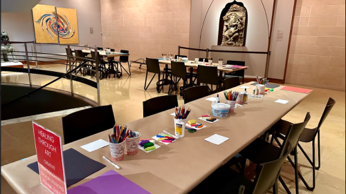 Craft tables set up in the Rubin Museum for the healing through art initiative. The Rubin resembles a church on the inside.