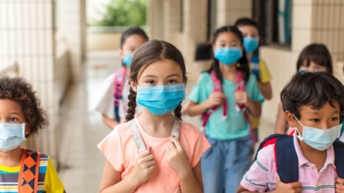 Children walking at school with masks on 