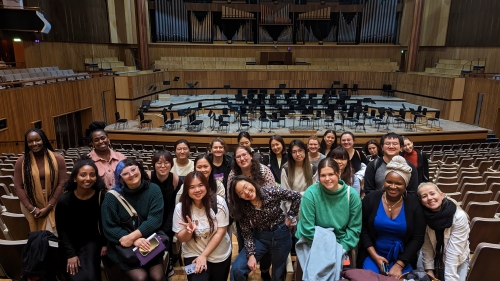 Large group of students abroad in London in a theatre
