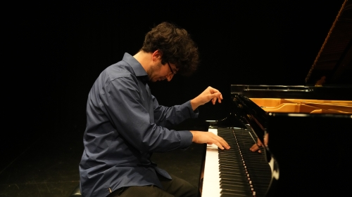 Student at the piano performing