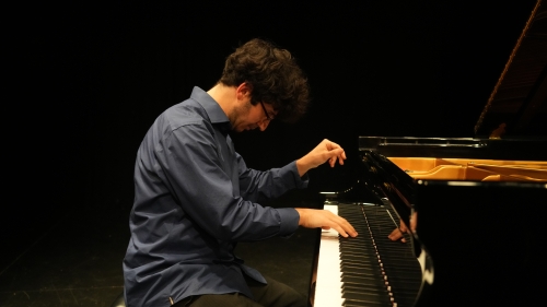 Student at the piano performing