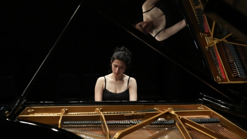 Honors student performing on grand piano