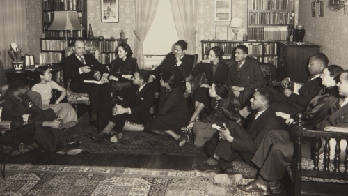 James Weldon Johnson speaking with 14 students, all sitting down