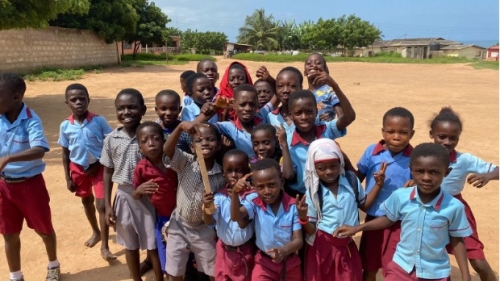 School children posing for a photo in their new school uniforms