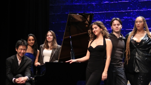 students and pianist posing at piano