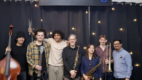 Students from Jazz Studies stand in front of WBGO radio sign