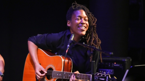 Performer playing guitar and singing