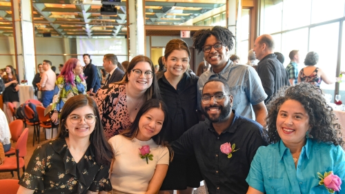 Members of the Teaching and Learning team and others pose at a dining table