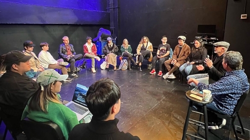 Large circle of students sitting during a guest lecture