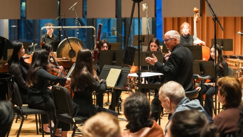Conductor Jonathan Haas leading orchestra