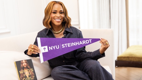 Picture of Eve holding an NYU Steinhardt Penant