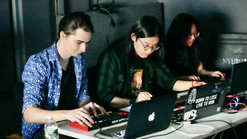 Three music tech students working on laptops