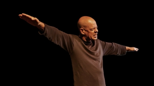 Performer on stage with arms stretched like an airplane