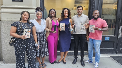 6 people pose for the photo, holding copies of the book "How the Word Is Passed"
