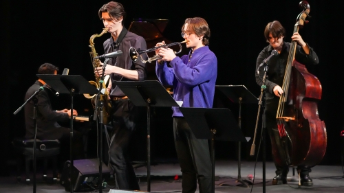 Four jazz players performing on stage