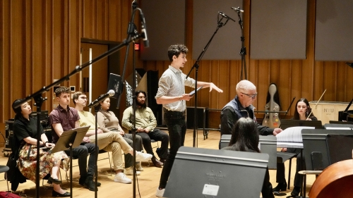 Composition student explaining piece of music to orchestra