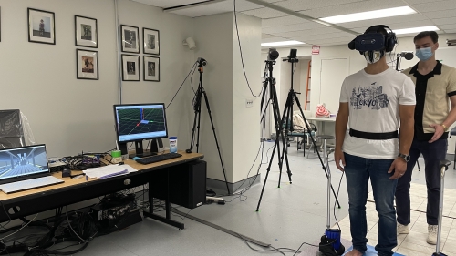 A study participant stands on a force platform that measures body movements, wearing a headset that measures head movements