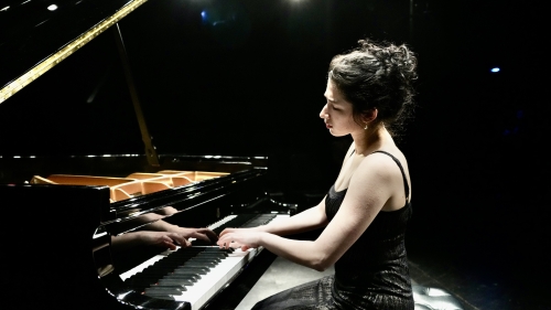 Piano student CiCi Fader playing a grand piano