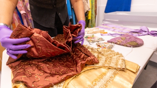 A student handles items from the costume studies archive
